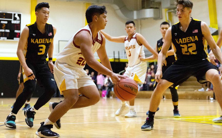 Father Duenas' Matt Santos is surrounded by Kadena defenders Casey Cox and Blake Dearborn during Friday's Kanto Classic boys game, won by the Panthers 48-41.