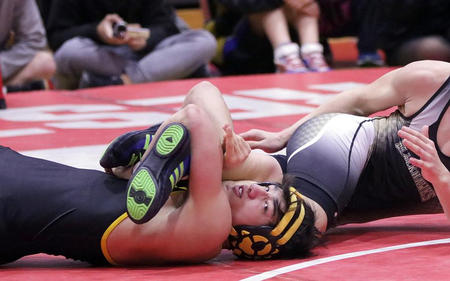 American School In Japan's Rin Zoot gets a leg lace on Humphreys' Jaiden Workman in the 148-pound final of Saturday's Nile C. Kinnick Invitational "Beast of the Far East" wrestling tournament. Zoot won by technical fall 10-0 in 48 seconds.