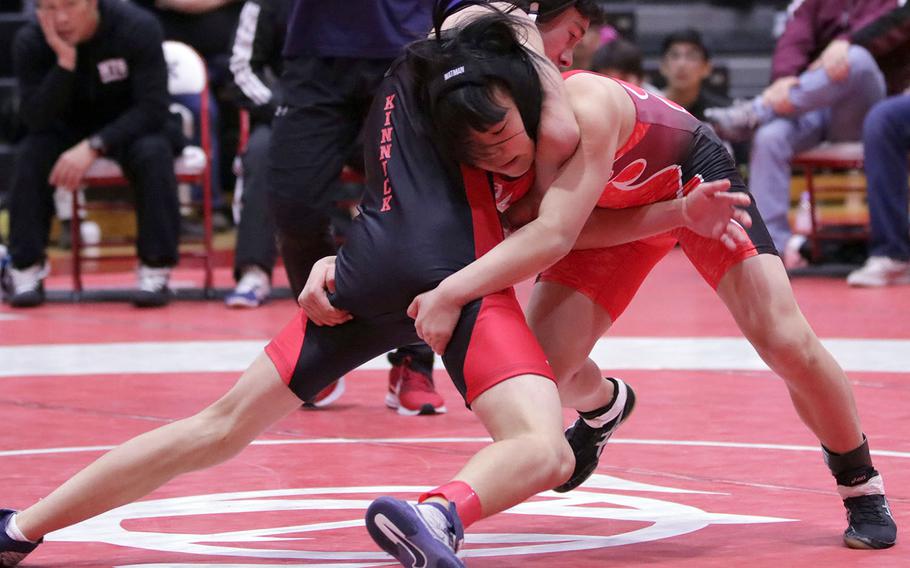 Shonan Military Academy's Mihoko Takeuchi tries to gain the upper hand on Nile C. Kinnick's Alexi Mutoh in the 101-pound final of Saturday's Nile C. Kinnick Invitational "Beast of the Far East" wrestling tournament. Takeuchi pinned Mutoh in 5 minutes, 11 seconds.
