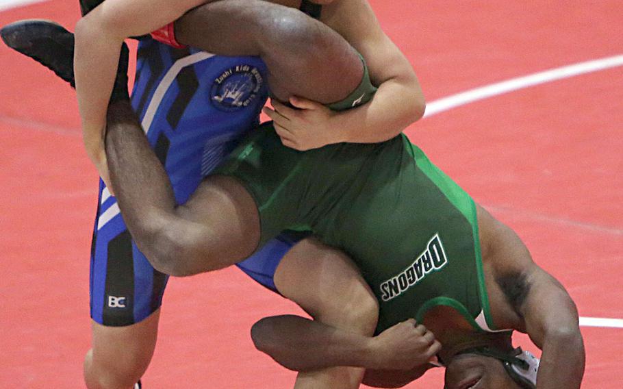 Shonan Military Academy's Taiga Hirooka turns Kubasaki's Jaylan Mayers upside down in the 122-pound final of Saturday's Nile C. Kinnick Invitational "Beast of the Far East" wrestling tournament. Hirooka won by technical fall 13-2 in 2 minutes, 54 seconds.
