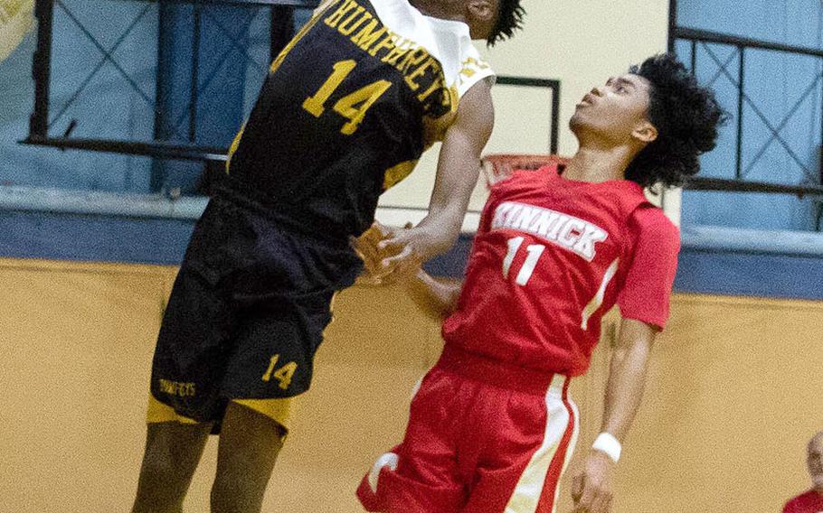 Humphreys' Jalen Hill goes up for a slam dunk against Nile C. Kinnick's Chris Watson.