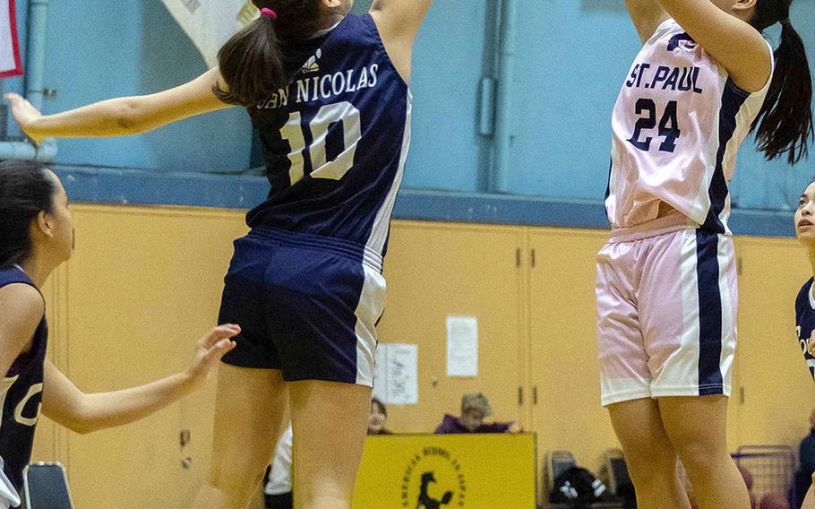St. Paul Christian's Niah Siguenza shoots against Academy of Our Lady of Guam's Mia San Nicolas.