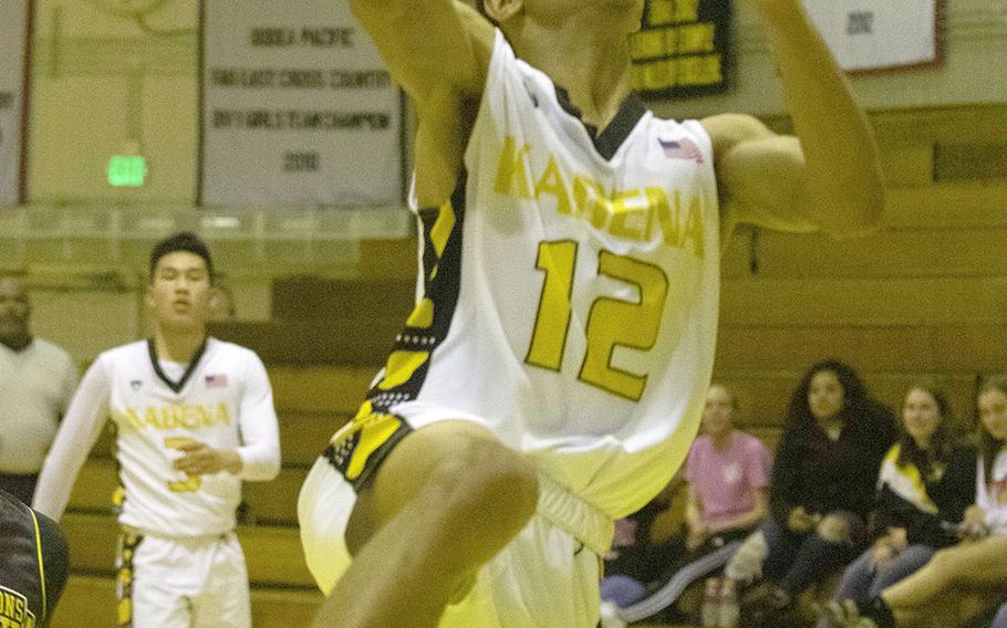 Kadena's Skyler King drives and scores against Kitanakagusuku during Wednesday's Okinawa boys basketball game. The Panthers won 75-62.