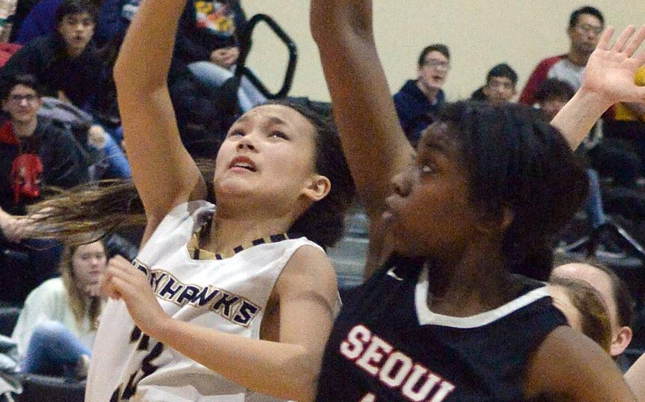 Humphreys' Trinity Barretto has her shot deflected by Seoul Foreign's Alexia Diamany during Friday's Korea Cup Tournament girls basketball game. The Blackhawks rallied for a 54-51 win.
