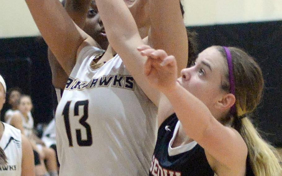Humphreys' Ebony Dykes gets sandwiched between Seoul Foreign's Alexia Diamany and Ilinca Clisson during Friday's Korea Cup girls basketball tournament game. The Blackhawks rallied for a 54-51 win.
