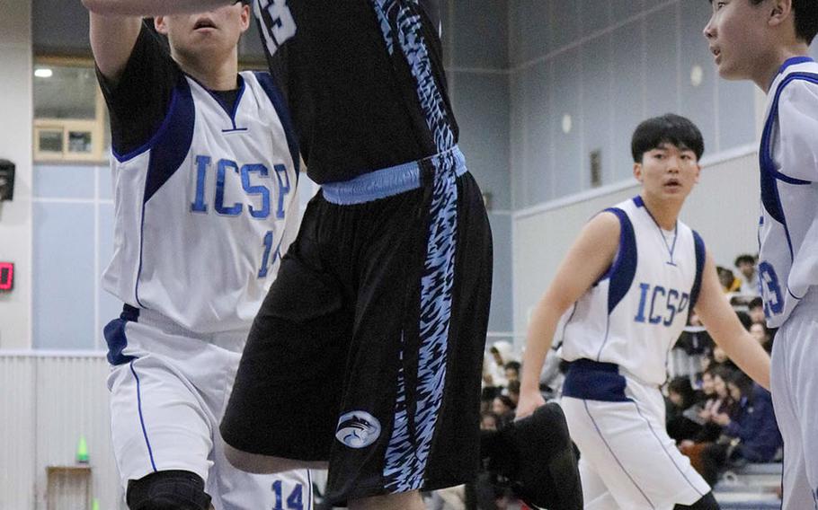 Osan's Carson Nugent shoots against International Christian-Pyongtaek during Friday's Korea Cup Tournament boys basketball game. The Cougars won 81-51.
