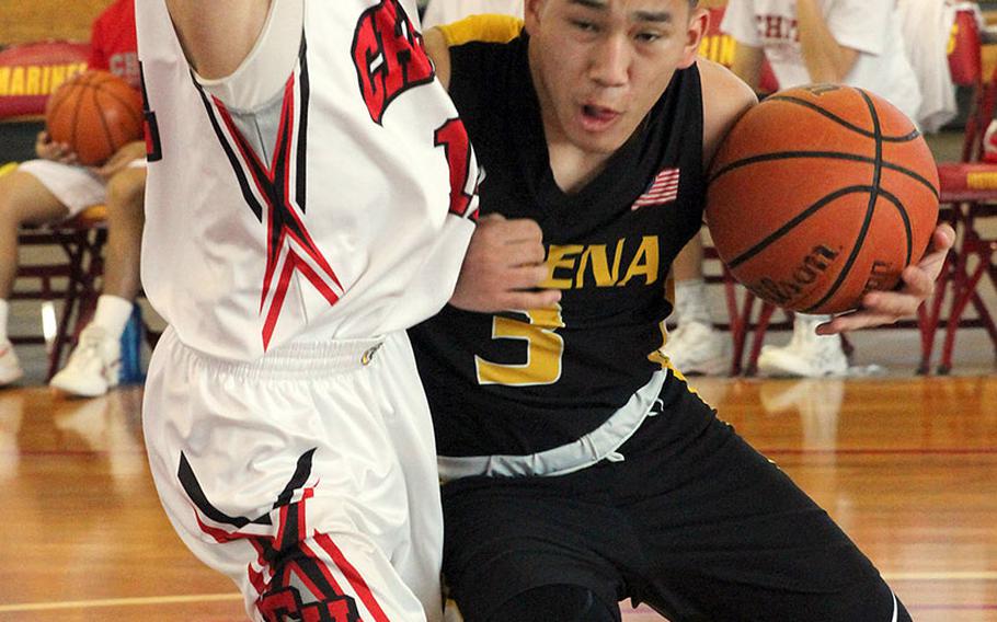 Kadena's Casey Cox crashes into a Chatan defender on Day 1 Saturday of the 13th Okinawa-American Friendship Tournament. The Panthers won 68-36.