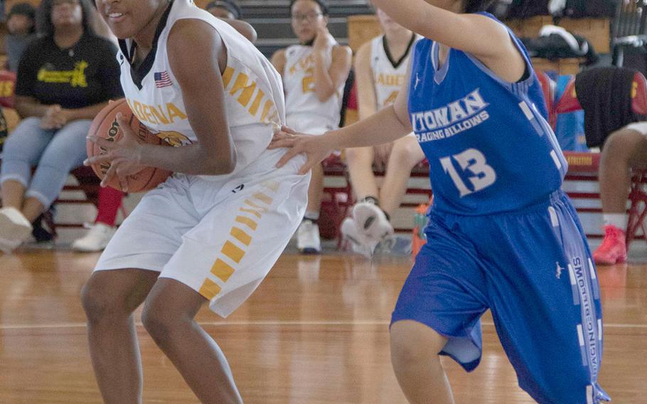 Kadena's Atirria Simms pulls up against an Itoman defender on Day 1 Saturday of the 13th Okinawa-American Friendship Basketball Tournament. The Raging Billows routed the Panthers 72-37.