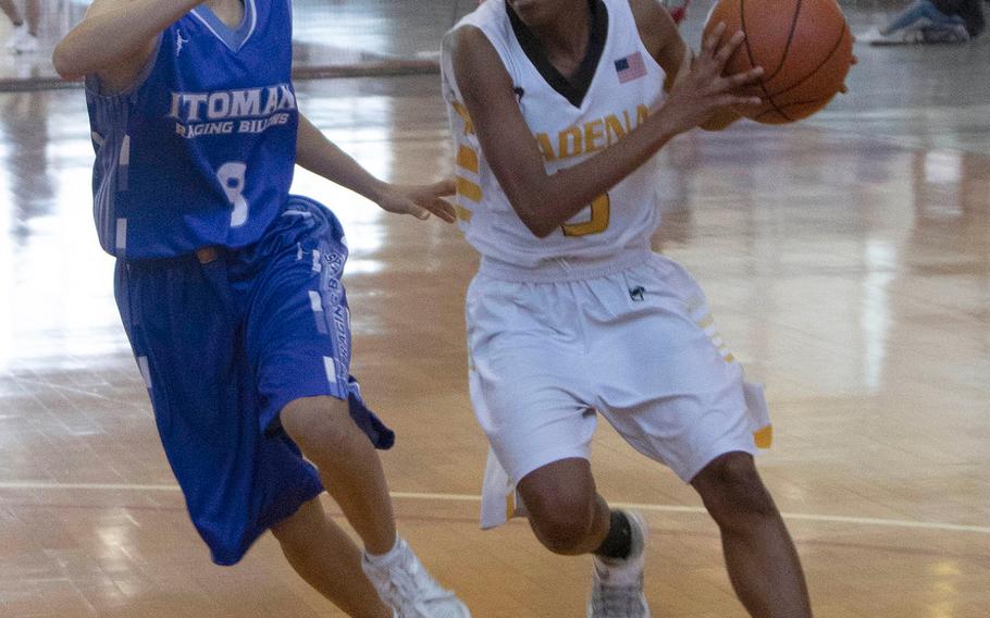 Kadena's Christee Dervil drives against Itoman on Day 1 Saturday of the 13th Okinawa-American Friendship Basketball Tournament. The Raging Billows routed the Panthers 72-37.
