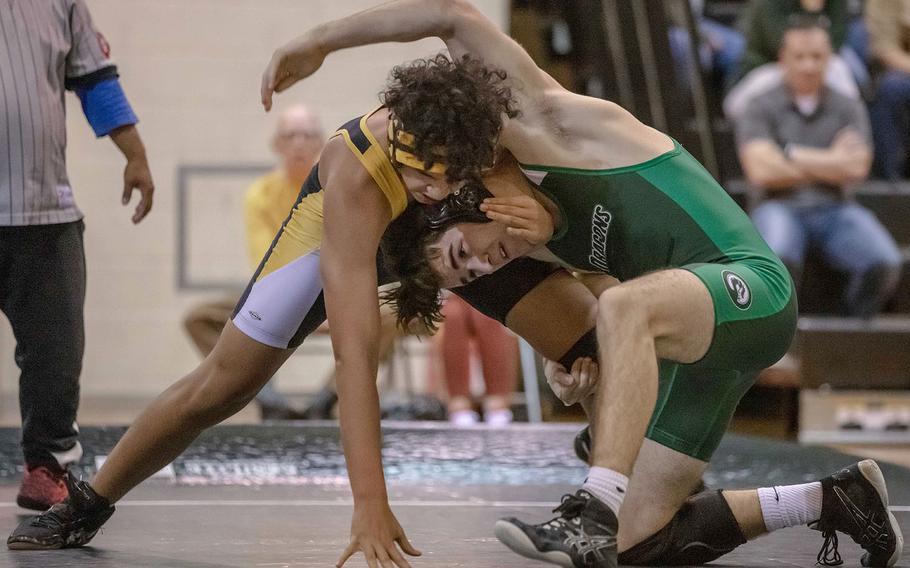 Kubasaki's Mike Moseley and Kadena's Finton Cawley fight for control at 158 pounds during Wednesday's Okinawa wrestling dual meet. Moseley pinned Cawley in 2 minutes, 42 seconds and the Dragons won the meet 57-7.