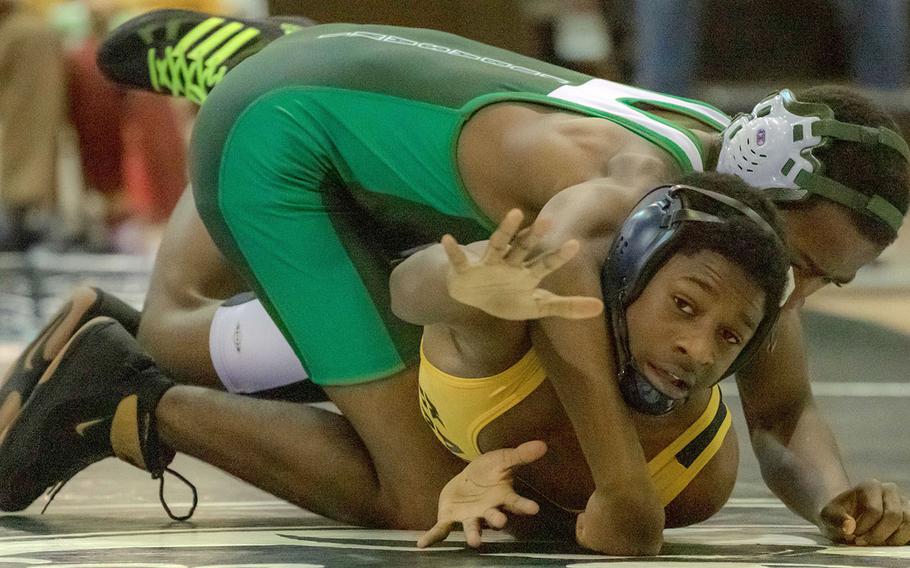 Kadena's Crisean Covington tries to escape the hold of Kubasaki's Jaylan Mayers at 122 pounds during Wednesday's Okinawa wrestling dual meet. Mayers pinned Covington in 4 minutes, 10 seconds, and the Dragons won the meet 57-7.