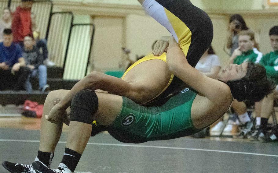 Kubasaki's Caleb Orr does a gut lift on Kadena's Gabriel Barrientos at 129 pounds during Wednesday's Okinawa wrestling dual meet. Orr pinned Barrientos in 50 seconds and the Dragons won the meet 57-7.