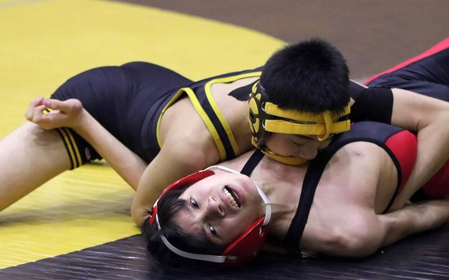 American School In Japan's Katsumi Tokunaga tries to finish off Nile C. Kinnick's Anthony Rodrigues at 108 pounds during Tuesday's Japan wrestling dual meet. Tokunaga pinned Rodrigues in 1 minute, 25 seconds and the Mustangs won the meet 42-20.