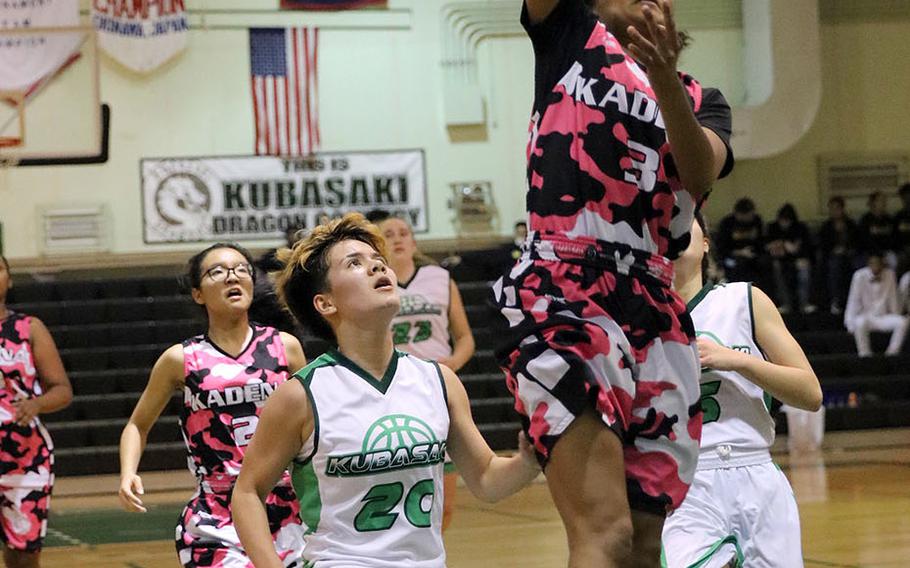 Kadena's Korina Macato skies toward the basket against Kubasaki's Ari Gieseck during Friday's Okinawa girls basketball game. The Panthers won 52-24 to sweep the regular-season series 4-0.