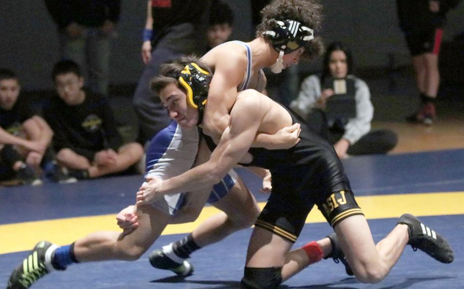 American School In Japan's Ira Kadet and Yokota's Chris DeGrella grapple for control in the 122-pound final of Tuesday's Kanto Plain Association of Secondary Schools finals at St. Mary'sl. Kadet pinned DeGrella in 1 minute, 46 seconds.