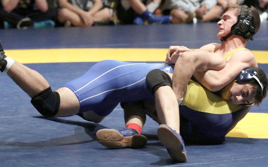 Yokota's Austin Fisher and St. Mary's Austin Koslow grapple for the advantage in the 180-pound final of Tuesday's Kanto Plain Association of Secondary Schools finals at St. Mary's. Koslow won by technical fall 10-0.