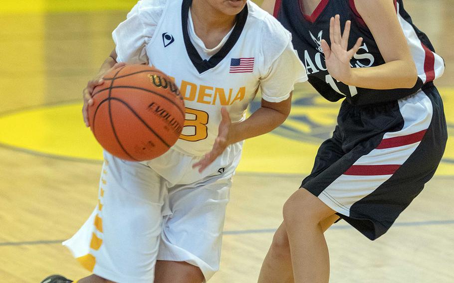 Kadena's Korina Macato drives past American School Bangkok's Marimo Kobori during Thursday's round-robin Division I Far East tournament game. The two-time defending champion Eagles routed the host Panthers 53-32.