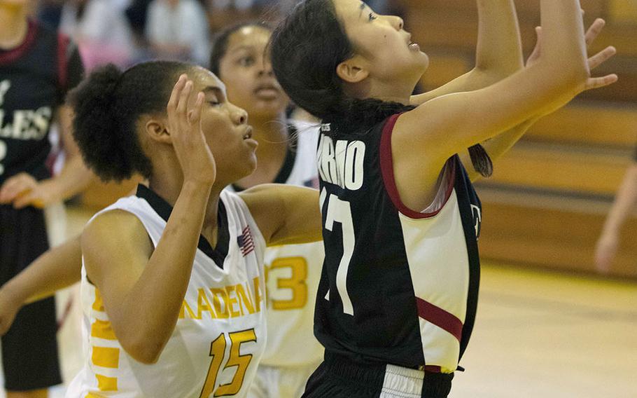 American School  of Bangkok's Marimo Kobori drives past Kadena's Kyleigh Wright for a shot during Thursday's round-robin Division I Far East tournament game. The two-time defending champion Eagles routed the host Panthers 53-32.