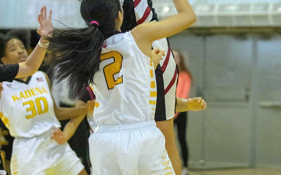 American School Bangkok's Shanique Lucas blocks a shot by Kadena's Grace Okubo during Thursday's round-robin Division I Far East tournament game. Two-time reigning Most Valuable Player Lucas and the two-time defending champion Eagles routed the host Panthers 53-32.