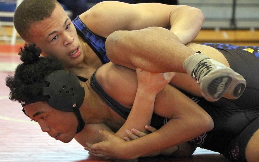 Yokota's Mack Togan gains control of Matthew C. Perry's Shawn Swindell during a 158-pound Far East tournament bout. Togan remains alive in the consolation bracket for a shot at third place.