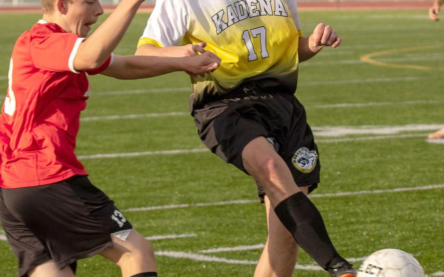 Kadena's Isaac Foster tries to send the ball downfield against Okinawa Christian during Friday's Okinawa boys soccer match, won by the Panthers 4-0.