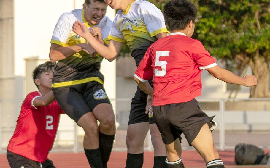 Kadena's Sean Fletcher and Nao Heckerman go up to head the ball between two Okinawa Christian defenders during Friday's Okinawa boys soccer match, won by the Panthers 4-0.