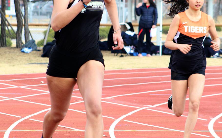 Humphreys senior Ebony Dykes, left, running in the 400, dominated girls field events, taking first place in the shot put, high jump and discus during Saturday's Humphreys Invitational track and field meet.