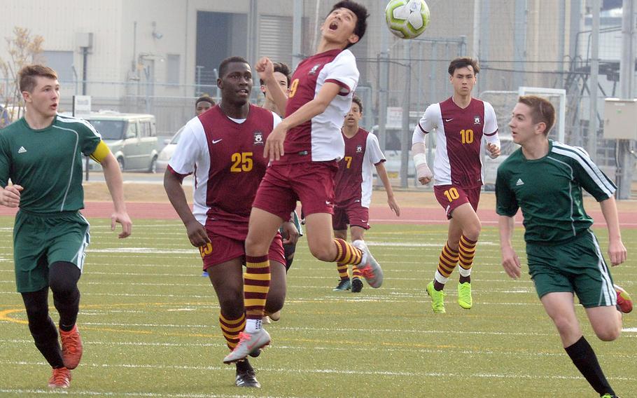 Matthew C. Perry's Yugo Cooley heads the ball between Robert D. Edgren defenders during Friday's Perry Cup boys soccer match at Marine Corps Air Station Iwakuni, Japan. The Samurai won 5-0. Perry went on to qualify for Saturday's fifth-place match; the Eagles play Saturday for ninth place.