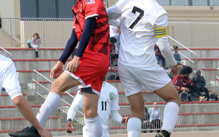 Nile C. Kinnick's Kai Sullivan and Kubasaki's Sinjin Pharathikoune go up to head the ball during Friday's Perry Cup match at Marine Corps Air Station Iwakuni, Japan. The Red Devils edged the Dragons 2-1. Both teams went on to reach Saturday's semifinals.