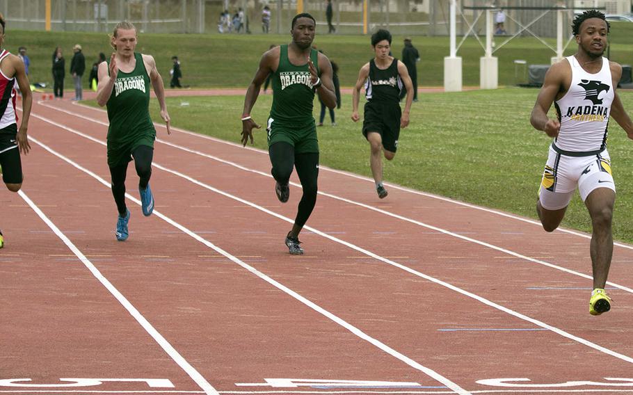 Kadena's Eric McCarter leads the field to the finish of the 100 meters during Saturday's Okinawa track and field meet. McCarter won both the 100 and 200.