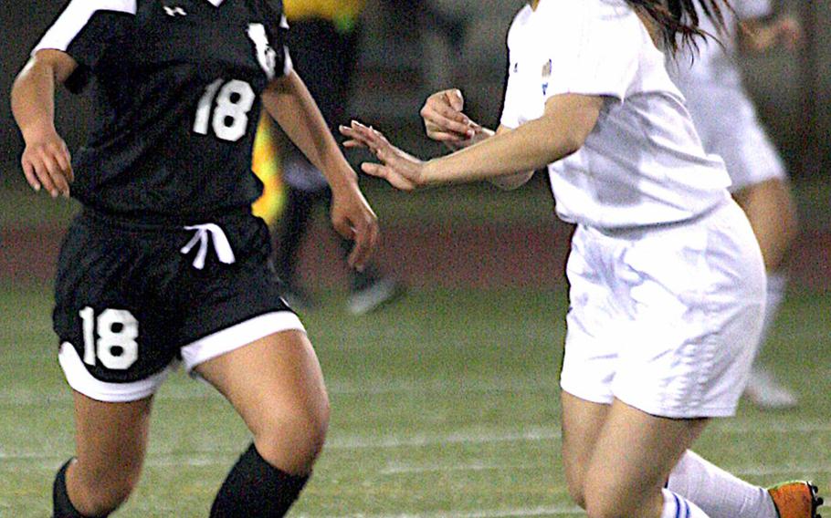 Zama's Morgen Barrozo and Yokota's Keiya Carlson battle for the ball during Tuesday's Japan girls soccer match, won by the Panthers 1-0.
