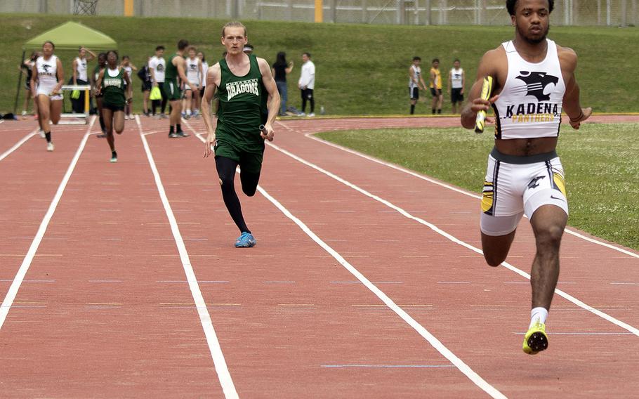 Kadena senior Eric McCarter pounds for the finsh of the 400 relay during Saturday's Okinawa track and field meet. The Panthers won all three relays, with McCarter also running a leg of the 1,600 relay and winning the 100 and 200 to boot.