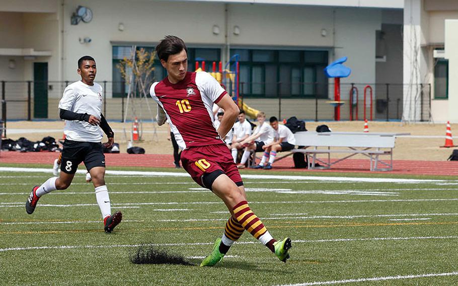 Matthew C. Perry's Kai Lange fires the ball toward the net ahead of several Zama players during Saturday's Japan boys soccer match. Lange scored a hat trick, giving him a Pacific-leading 17 goals on the season, as the Samurai won 6-0.