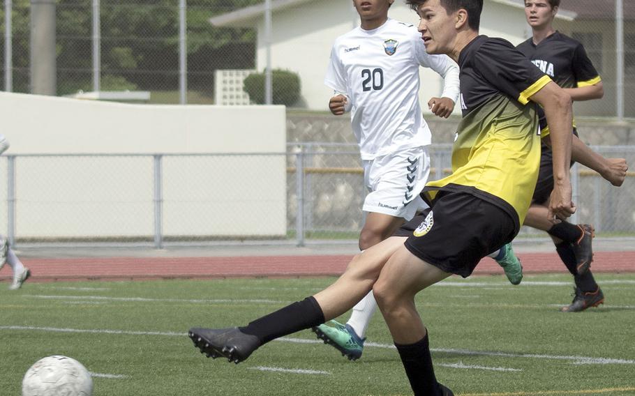 Kadena's Kael Beck boots the ball upfield against KBC Mirai during Sunday's Okinawa boys soccer match. The teams played to a 2-2 draw.