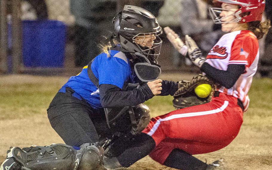 Nile C. Kinnick's Michaela Hall slides into the tag of Yokota catcher Becca Bauman during Tuesday's Japan softball game. The Red Devils won 17-9, ending the Panthers' eight-game winning streak.
