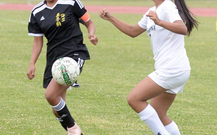 Kadena's Korina Radel plays the ball against Kubasaki's Angelica Figueroa during Wednesday's Okinawa girls soccer match, won by the Panthers 2-0.