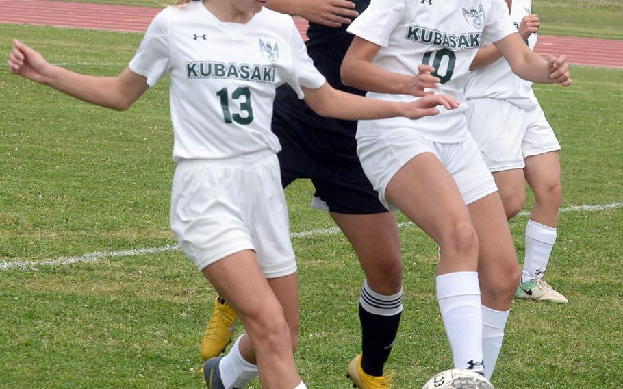 Kubasaki's Amara Mitton and Natalie Mulherin play keep away with the ball against Kadena's Alyssa Balbuena during Wednesday's Okinawa girls soccer match, won by the Panthers 2-0.