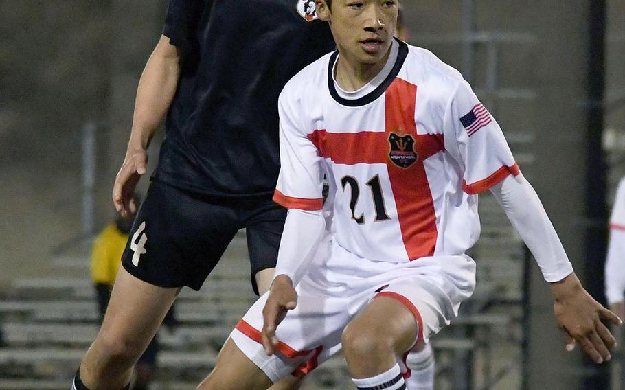 Nile C. Kinnick's Kai Downs fields the ball in front of Zama's Milton Jones during Tuesday's Japan boys soccer match, won by the Red Devils 7-0.
