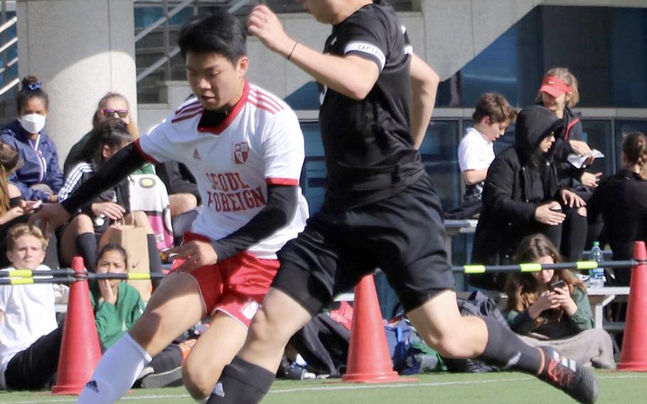 Daegu's Miciiah Ruff and Seoul Foreign's Daniel Kim chase the ball during Friday's Korea boys soccer match, won by the Crusaders 5-0.