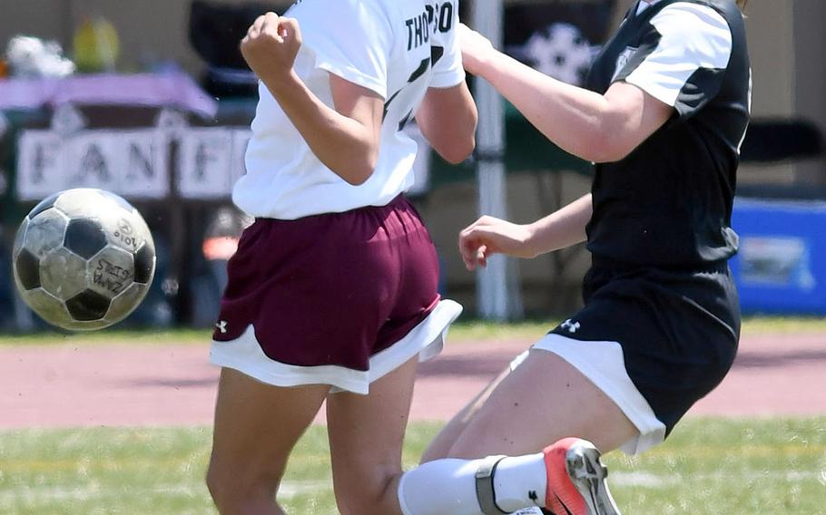 Matthew C. Perry's Sora Thompson and her former teammate, Zama's Siobhan Grabski, tussle for the ball during Thursday's DODEA-Japan girls soccer tournament opener. The Trojans won 3-0.