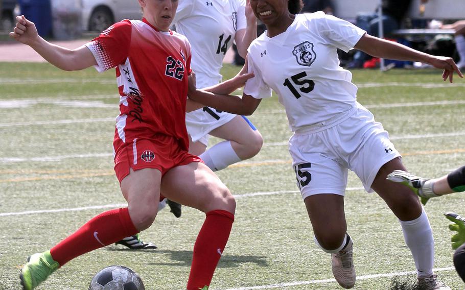 Nile C. Kinnick's Maggie Donnelly tries to shoot against Zama's Midori Robinson during Friday's DODEA-Japan girls soccer tournament match. The Red Devils won 3-2.