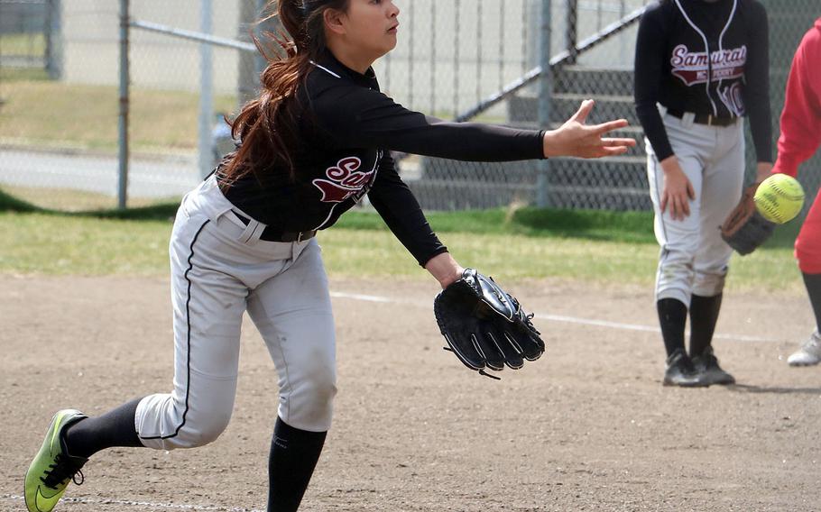 Matthew C. Perry's Xandra Bugawan delivers against Nile C. Kinnick during Friday's DODEA-Japan softball tournament game. The Red Devils won 10-0.
