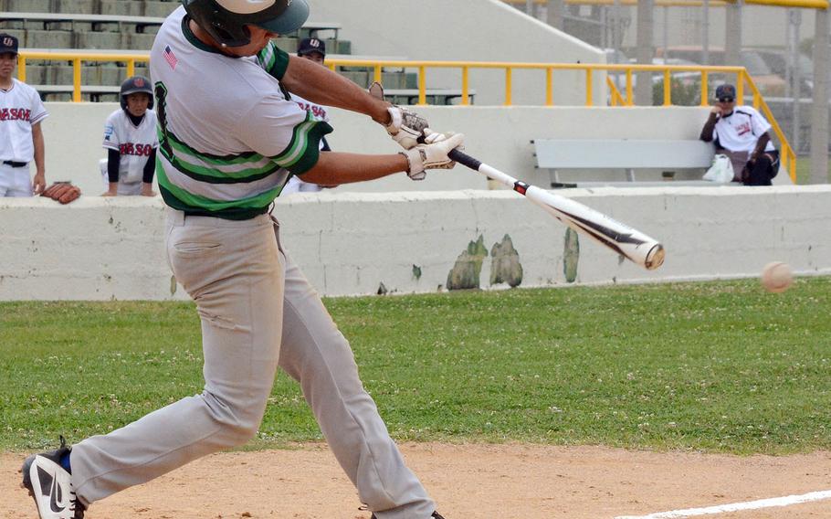 Kubasaki's Cruz Vega connects against Urasoe, a Japanese team, during Saturday's twin bill at Camp Foster, Okinawa. The Dragons lost the opener 9-3 and won the nightcap 15-14.