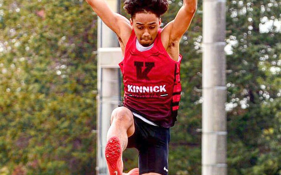 Nile C. Kinnick's Chris Watson leaps to victory in the long jump during Saturday's track and field meet at Yokota. Watson also won the 100 and 200.