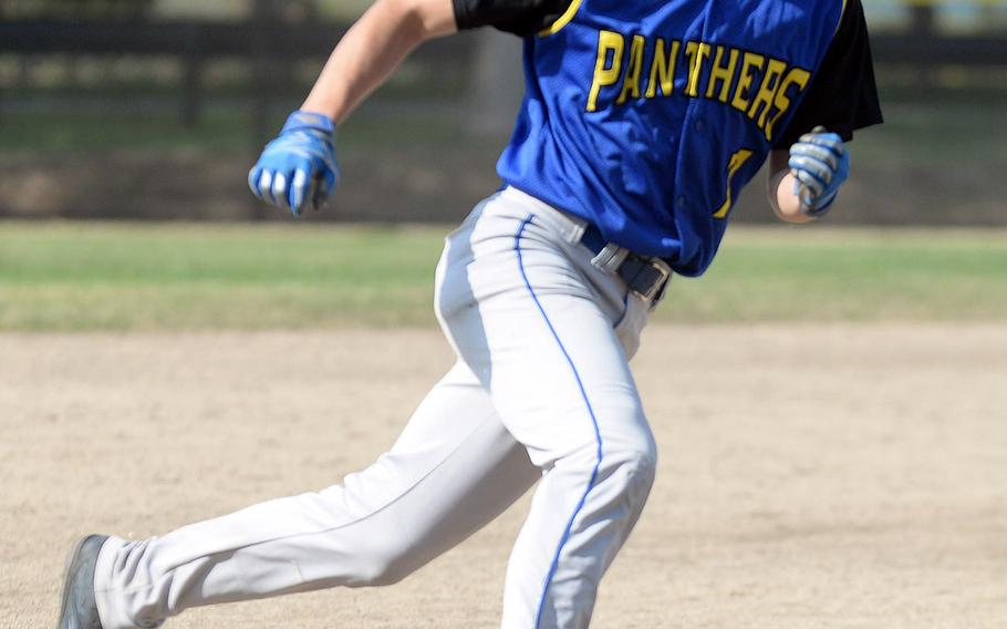 Yokota baserunner Glen Willingham charges around third base and heads for home against E.J. King during the final game Saturday in the DODEA-Japan baseball tournament. The Panthers won 8-0 to finish 4-0 and win the tournament for the fourth straight year.