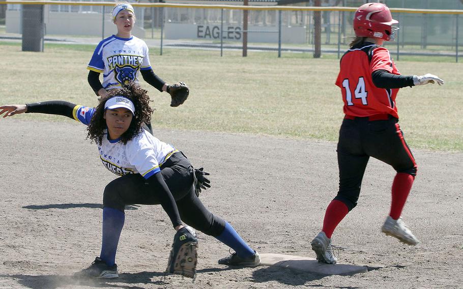 Nile C. Kinnick baserunner Rebecca Loffreda is safe at first as Yokota first baseman Isabella Mollison looks back for the ball during Saturday's DODEA-Japan softball tournament final. The Panthers won 11-9.