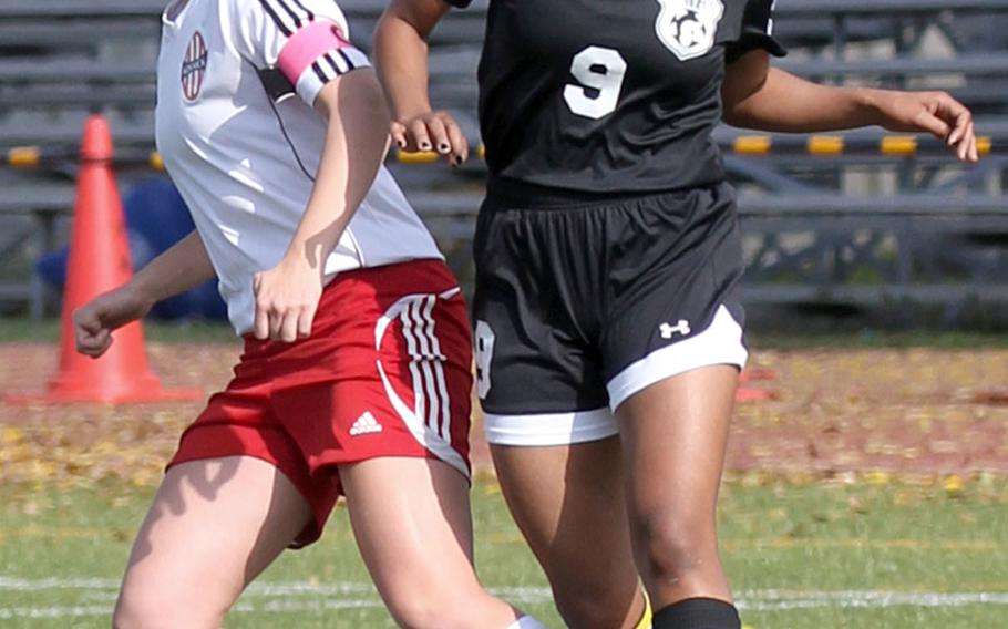 Zama's Kayesha McNeill heads the ball against Nile C. Kinnick's Jenna Lynch during Saturday's DODEA-Japan girls soccer tournament final. The Red Devils won 4-0.