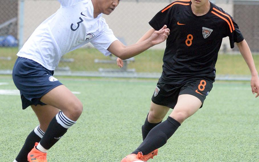 Osan's Lean Copia starts upfield against Seoul International's Eddie Hahm during Friday's Korea boys soccer Plate Tournament at Osan Air Base. The host Cougars won 3-0.