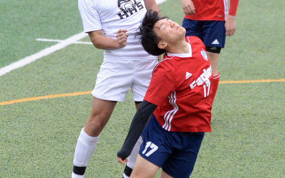Humphreys' Devin Donnell and International Christian-Uijongbu's Peter Tsung go up to head the ball during Friday's Korea boys soccer Plate Tournament match at Osan Air Base. The Blackhawks won 8-0.