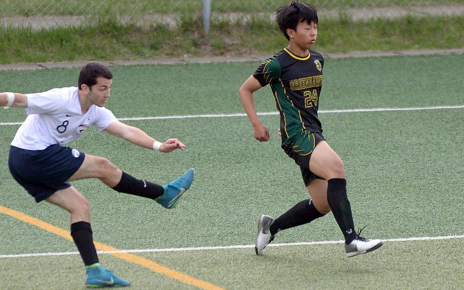 Osan's Joey Betts sends a crossing pass against Asia-Pacific's Scott Choi.
